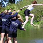 The Washington women’s rowing team celebrates Saturday’s victory by tossing its coxswain, Marlow Mizer, into Lake Washington. Source: John Lok/The Seattle Times