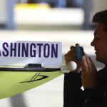 Jackson Droege snaps a photo of one of the shells belonging to the University of Washington crew team before the start of the 2015 Windermere Cup Saturday. Droege and the rest of the his teammates with Mount Baker Rowing Club were among the competitors. -Source: John Lok/The Seattle Times